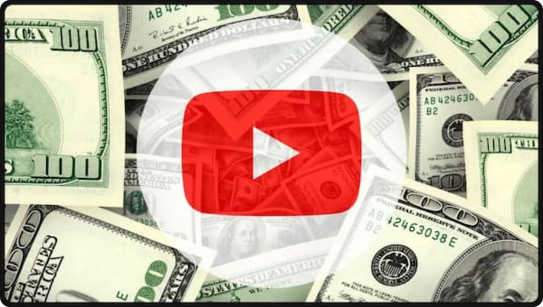 YouTube play button logo over a spread of $100 bills, representing YouTube monetization