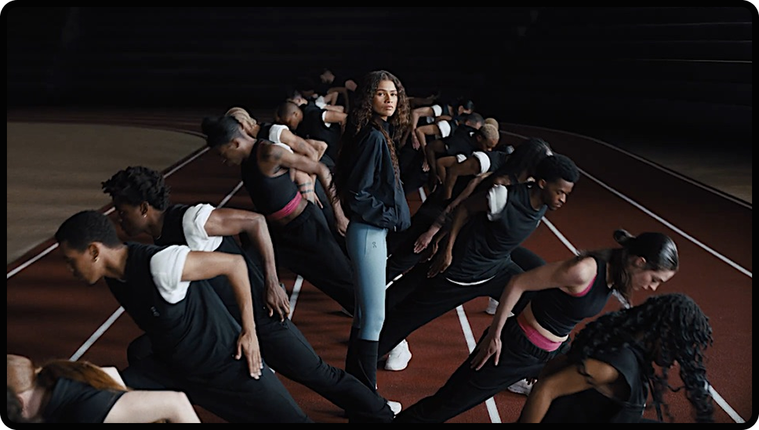 Zendaya and On collaboration imagery, people on track field with Zendaya in the middle facing the camera