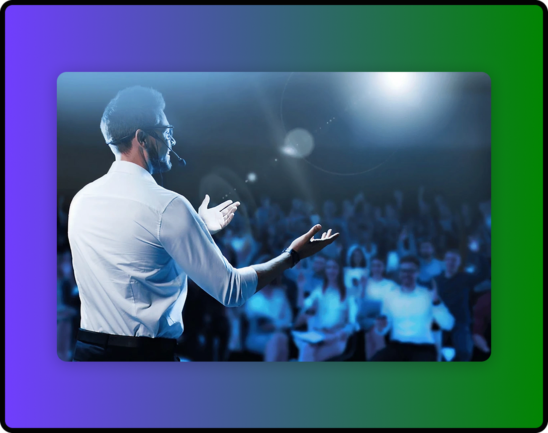 An executive standing up and speaking in front of a crowd.