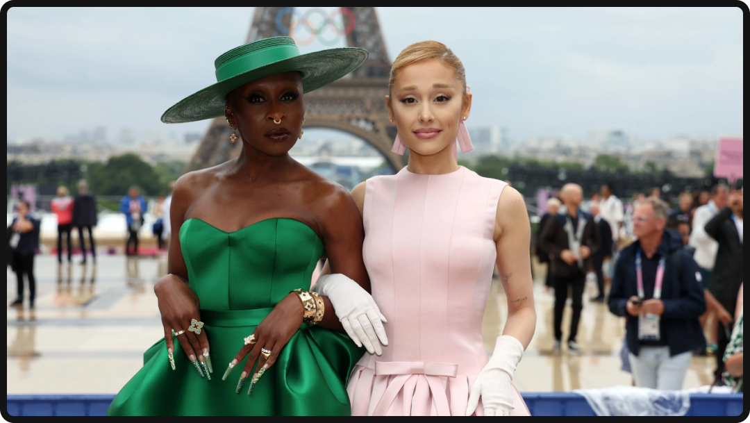 Photo of Ariana Grande and Cynthia Erivo posing in front of the Eiffel Tower.