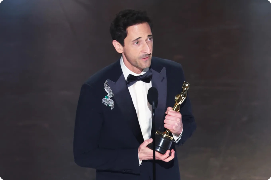 Image of Adrian Brody accepting an Oscar, whose dialogue was refined using AI.