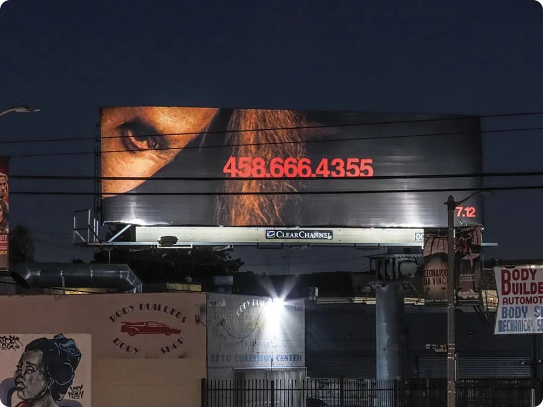 a viral promotional billboard in Los Angeles for the 2024 horror film Longlegs, featuring an intense character close-up and phone number